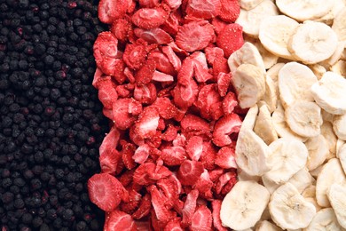 Photo of Closeupfreeze dried blueberries, strawberries and bananas as background, top view