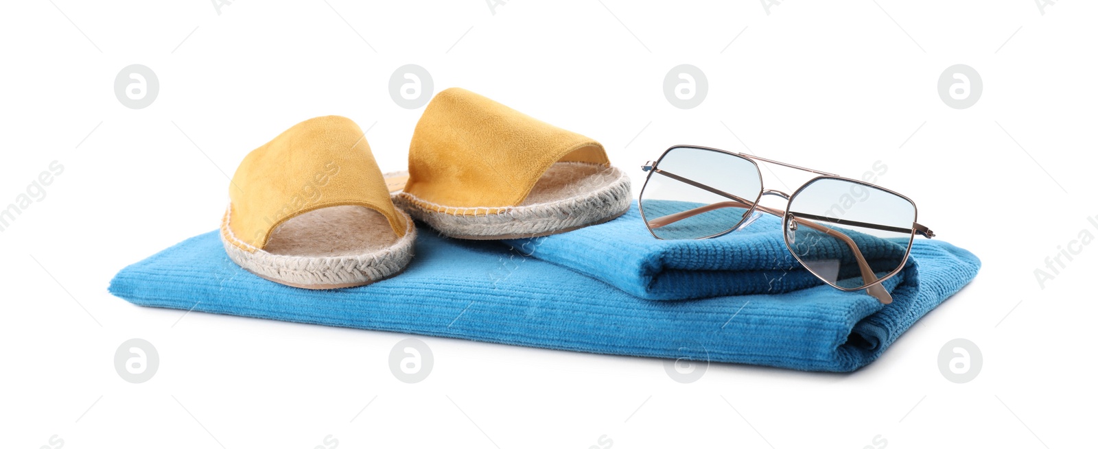 Photo of Blue towel, shoes and sunglasses on white background. Beach objects