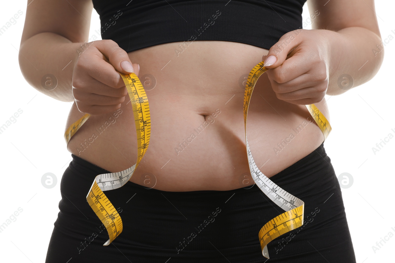 Photo of Woman measuring belly with tape on white background, closeup. Overweight problem