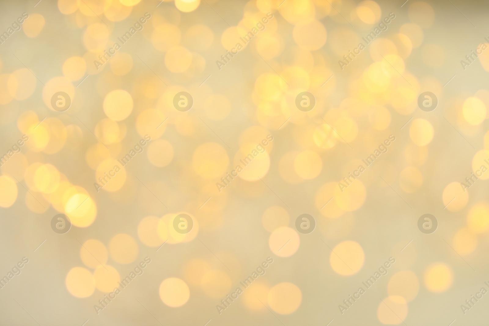 Photo of Gold glitter with bokeh effect on light background