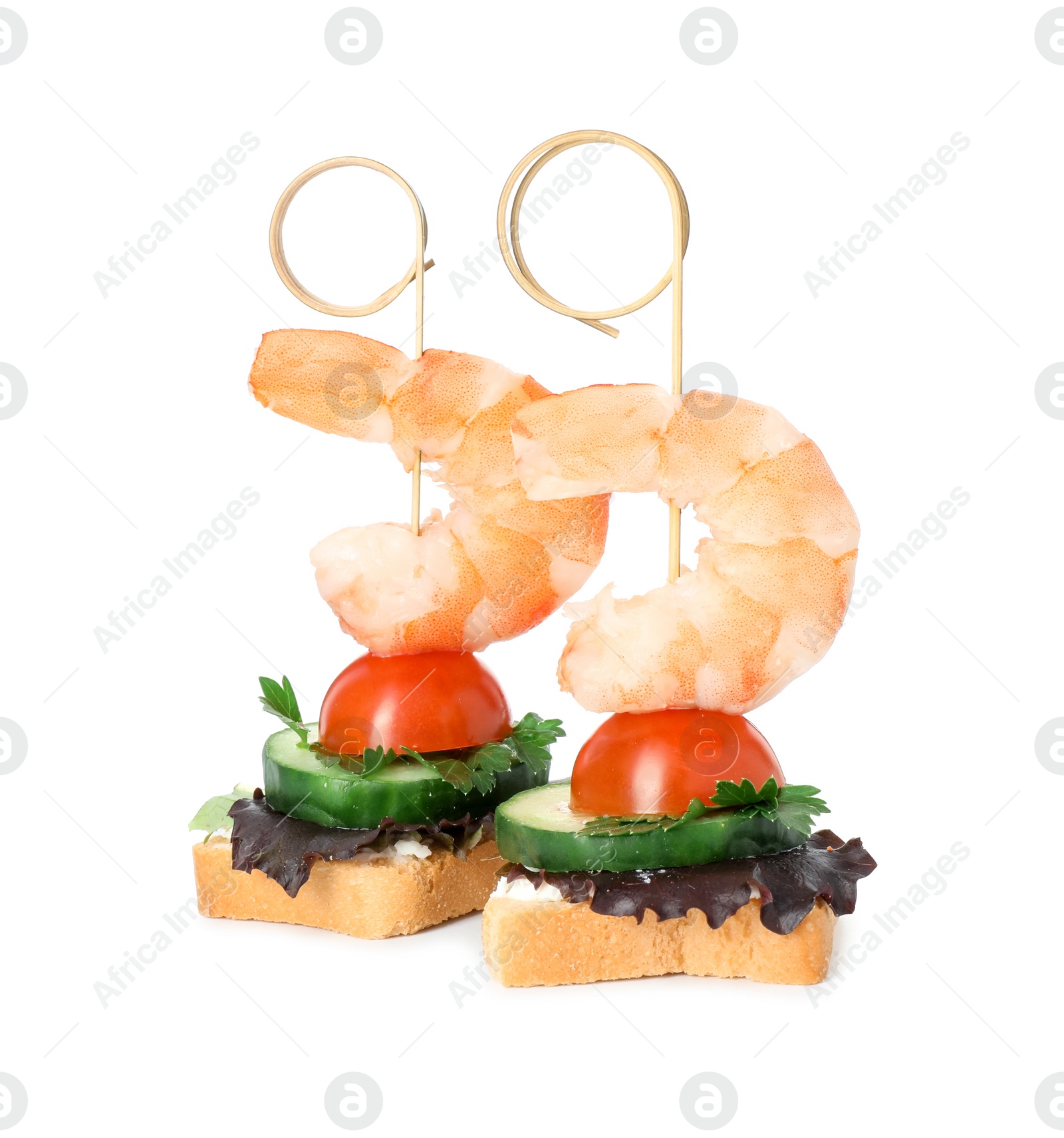 Photo of Tasty canapes with shrimps, cucumber, greens and tomato isolated on white