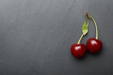 Photo of Delicious cherries with leaf on grey background, flat lay