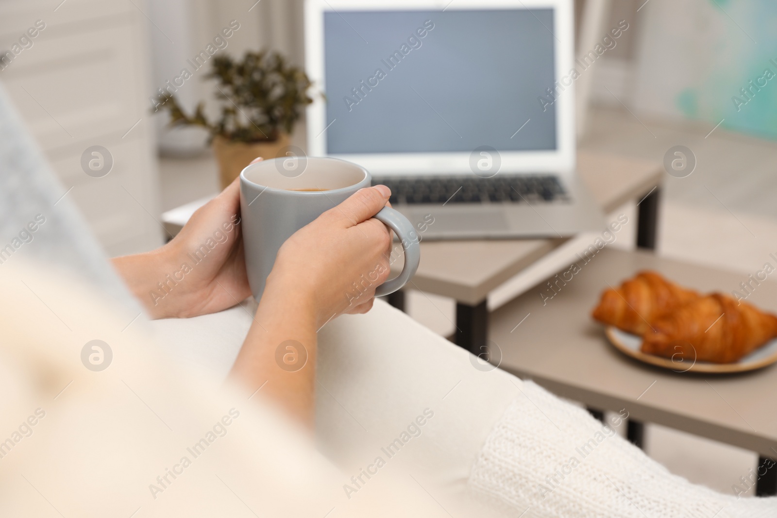 Photo of Woman with cup of coffee resting at home, closeup