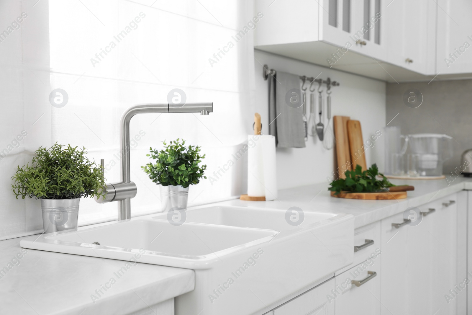 Photo of Different potted artificial plants on countertop in kitchen. Home decor