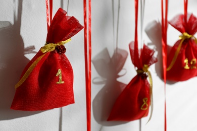 Photo of Christmas advent calendar hanging on white wall indoors