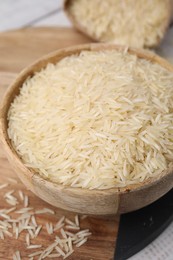 Raw rice in bowl on table, closeup