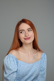 Portrait of beautiful woman on grey background