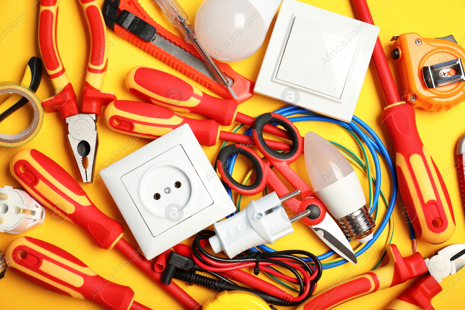 Photo of Set of electrician's tools on color background, top view