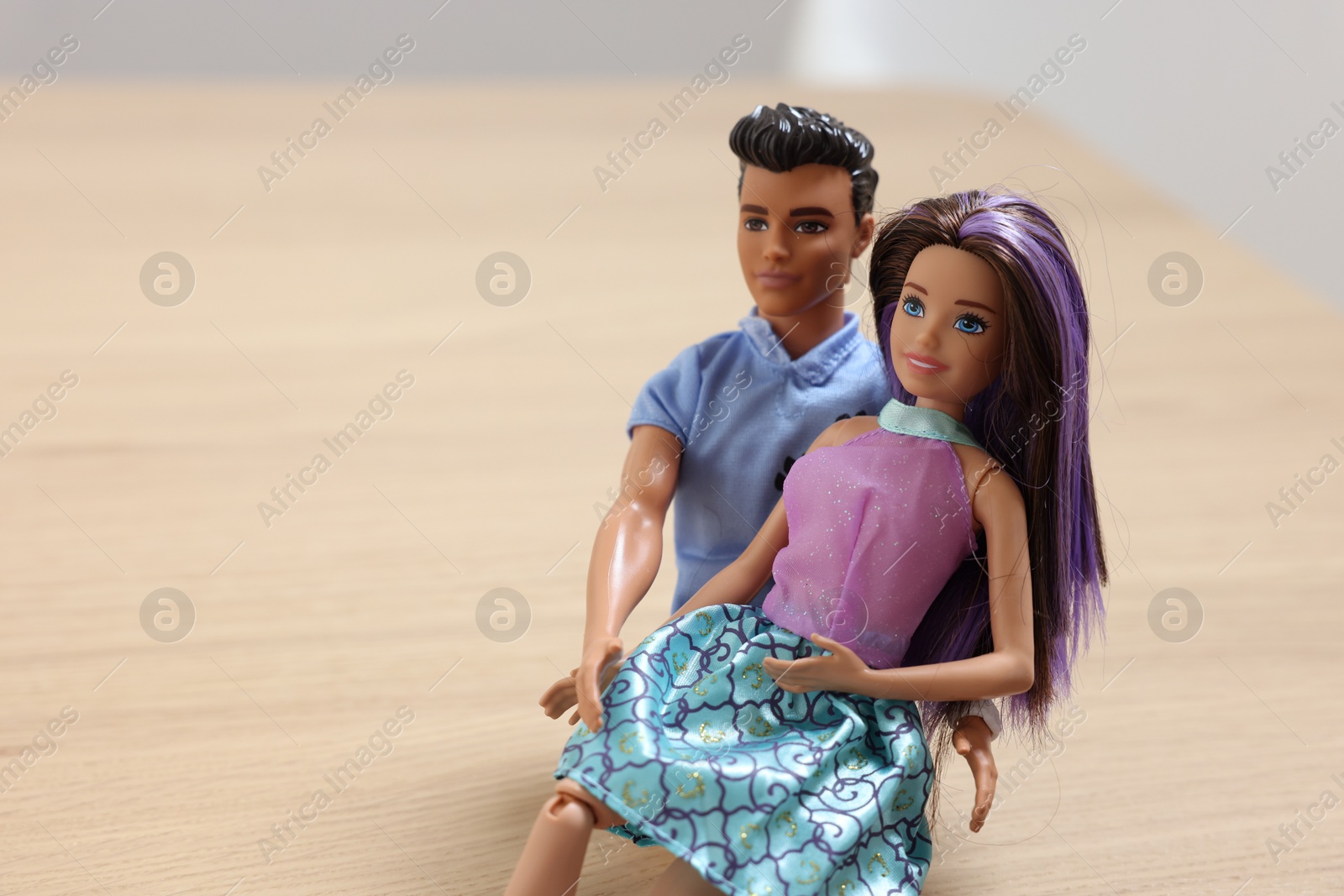 Photo of Leiden, Netherlands - September 20, 2023: Stylish Barbie and Ken dolls on wooden table, space for text