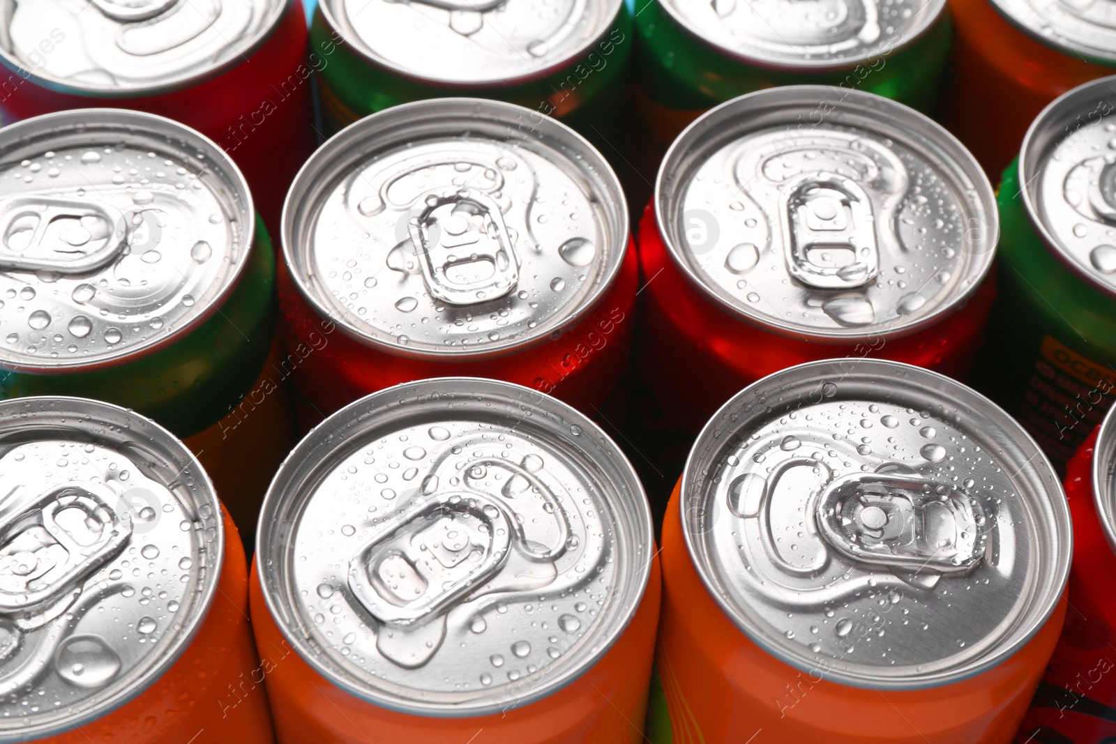 Photo of Energy drinks in wet cans, closeup. Functional beverage