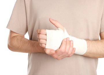 Photo of Man with hand wrapped in medical bandage on white background, closeup