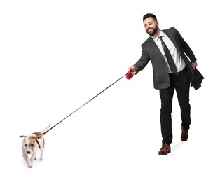 Smiling businessman walking with dog on white background