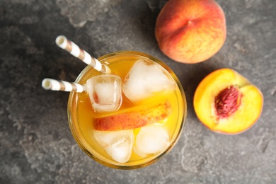 Tasty peach cocktail in glass on table, top view. Refreshing drink