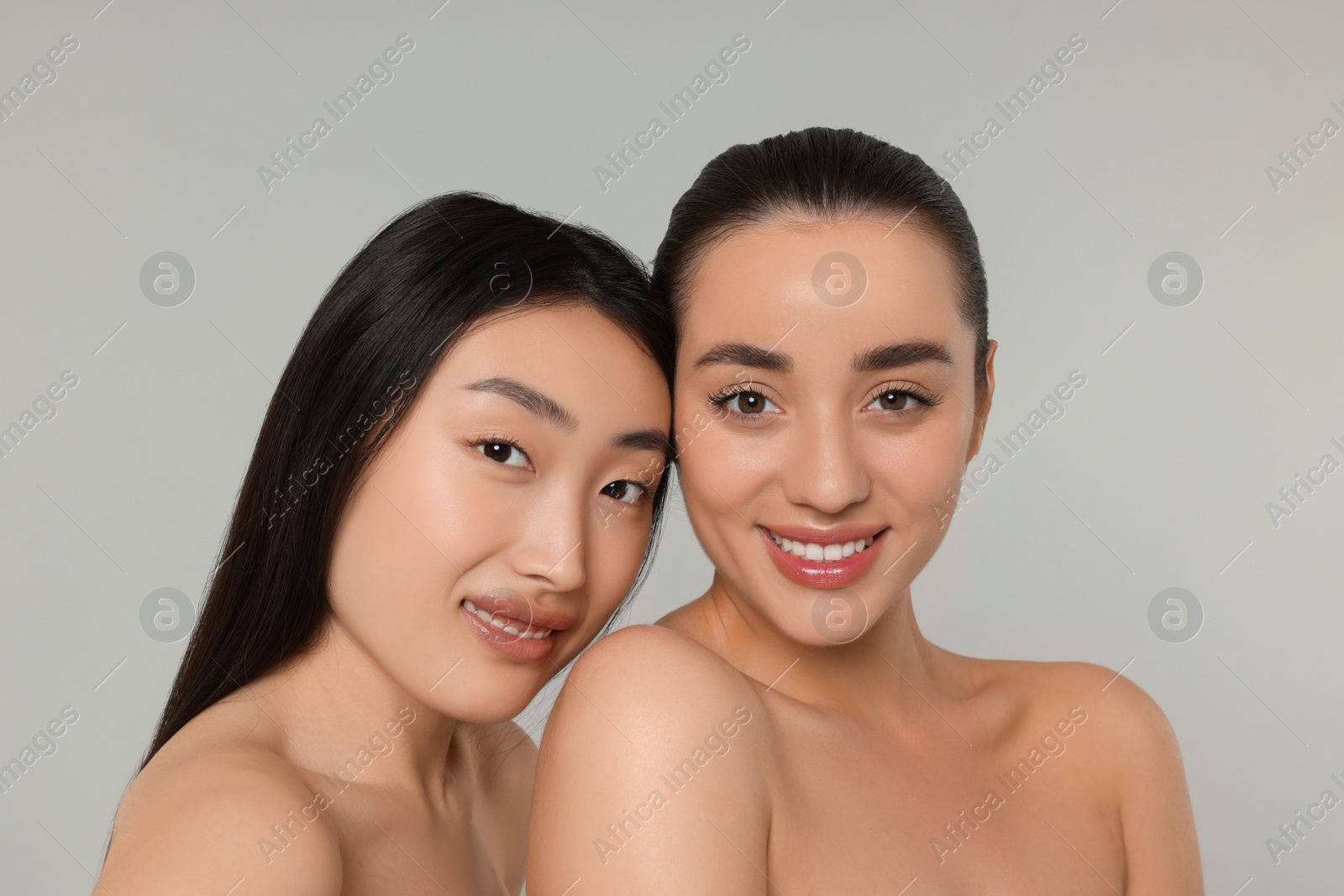 Photo of Portrait of beautiful young women on light grey background