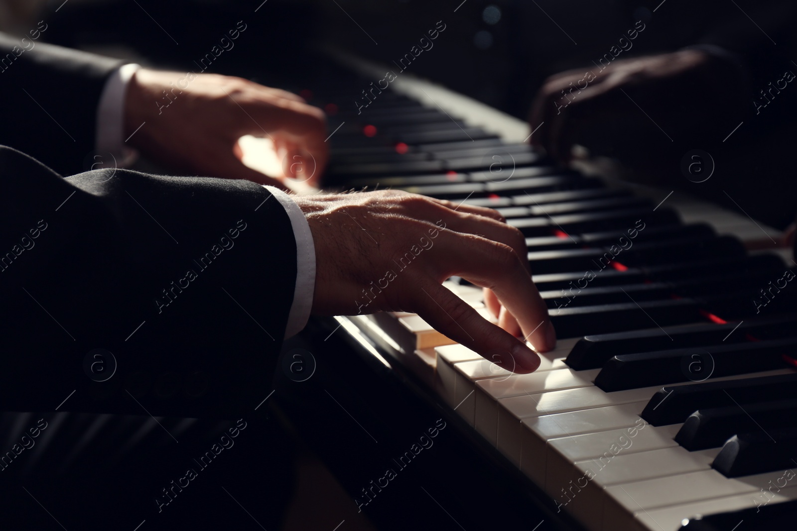 Photo of Man playing grand piano, closeup. Talented musician