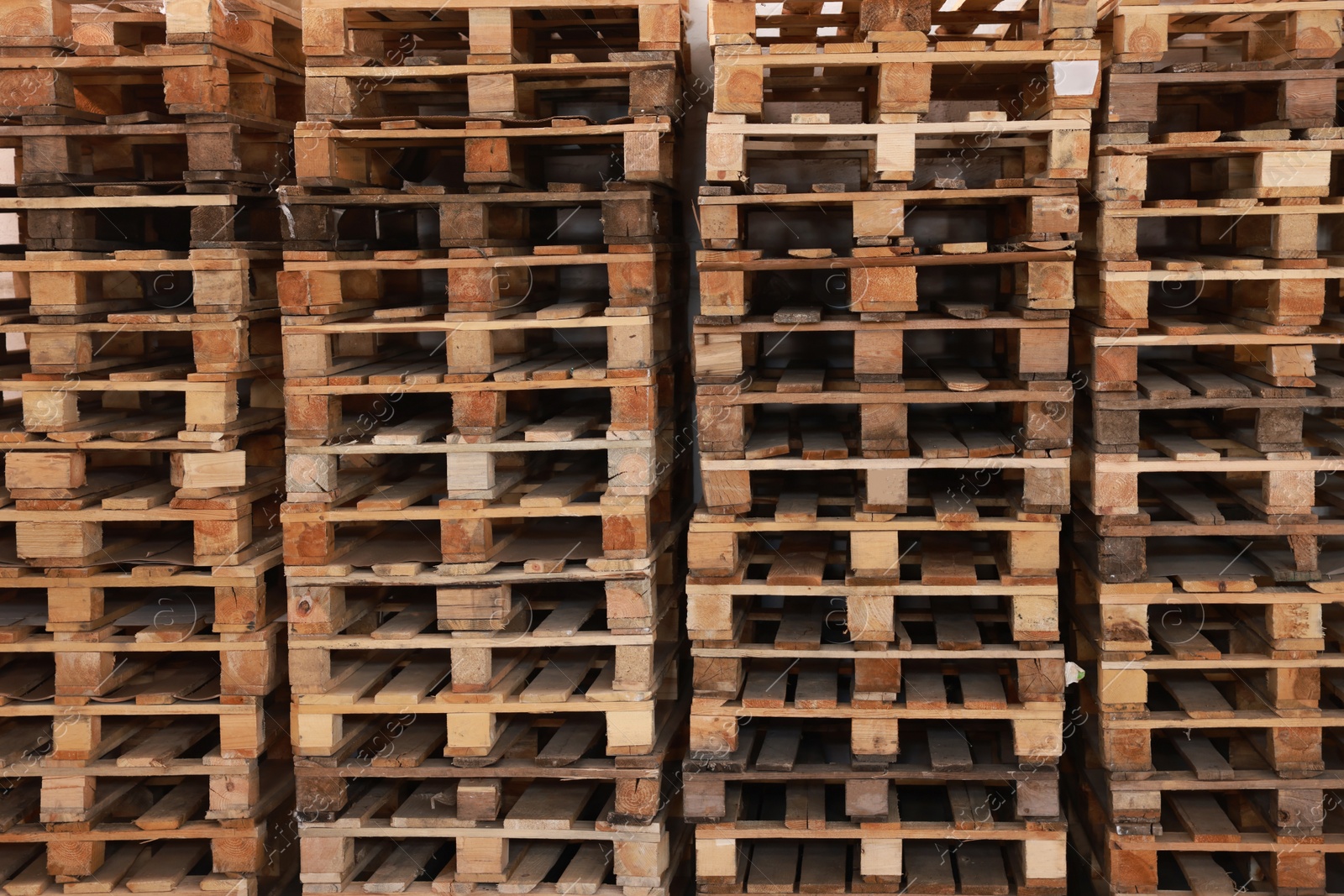 Image of Many empty wooden pallets stacked as background