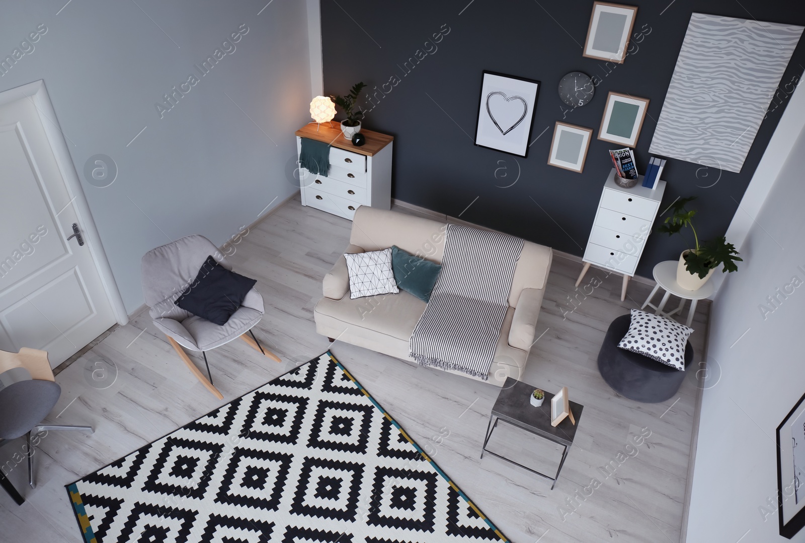 Photo of Living room interior with comfortable sofa and rocking chair, view through CCTV camera