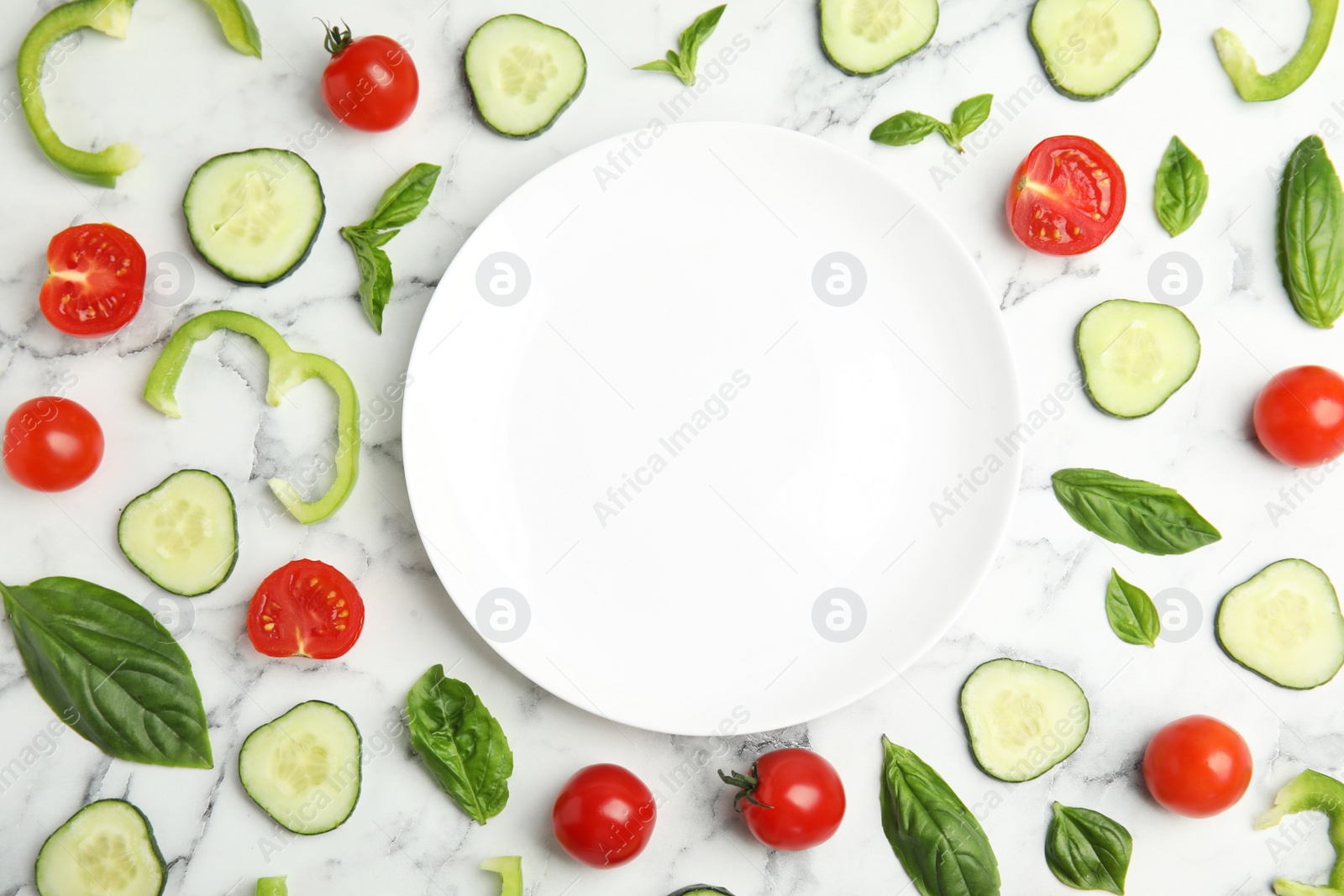 Photo of Flat lay composition with fresh salad ingredients on white marble table, space for text