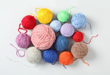 Photo of Soft colorful woolen yarns on white background, top view