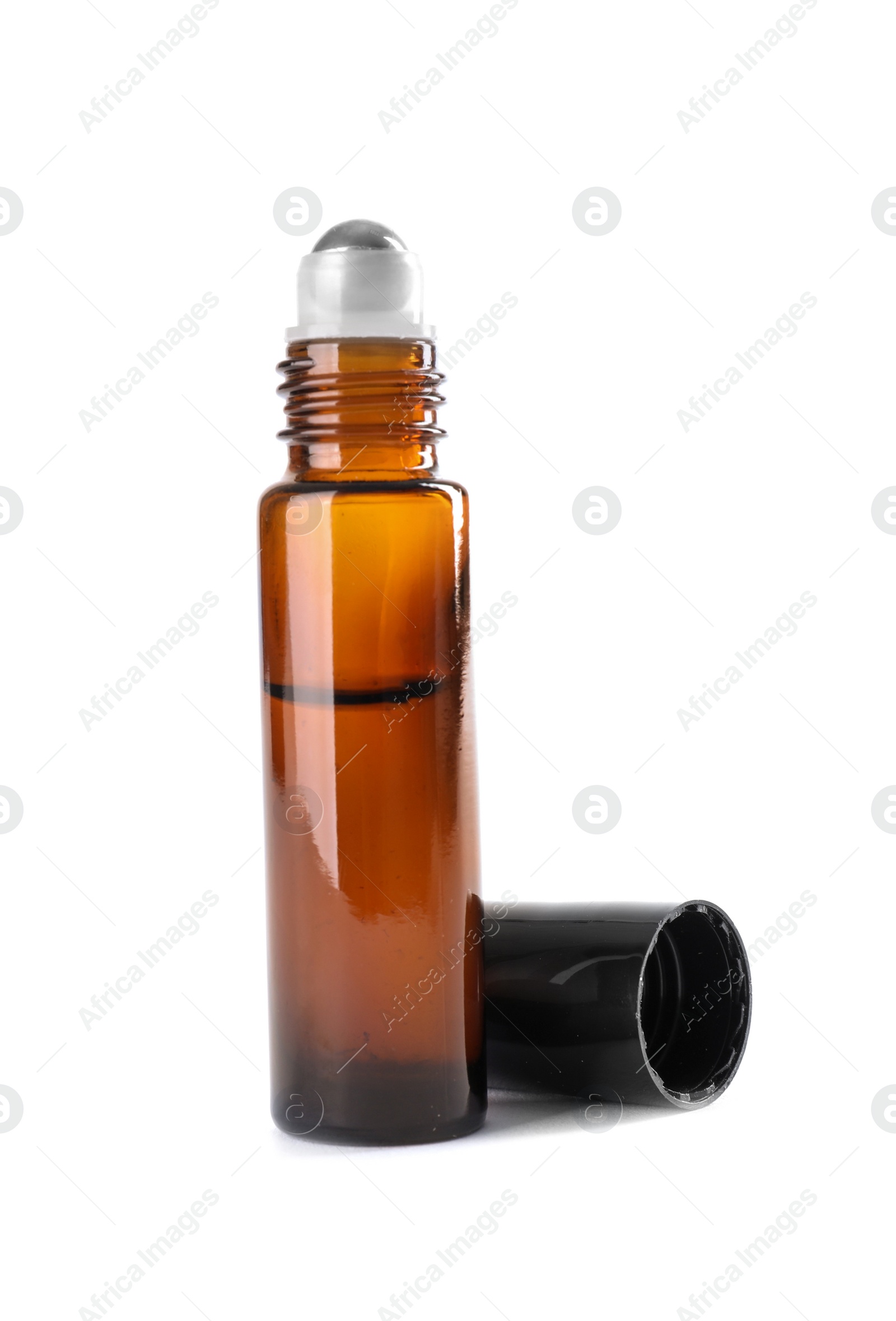 Photo of Bottle of herbal essential oil and cap isolated on white