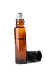 Photo of Bottle of herbal essential oil and cap isolated on white