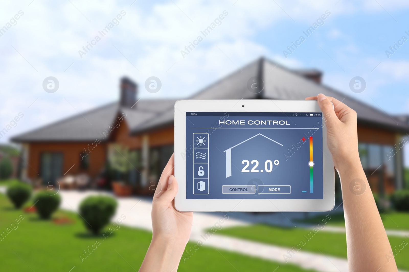 Image of Energy efficiency home control system. Woman using tablet to set indoor temperature, closeup