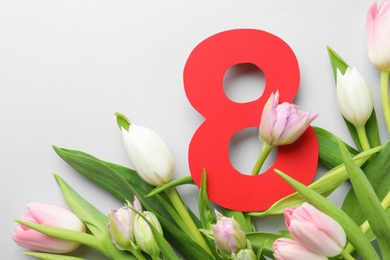 Photo of 8 March card design with tulips on light grey background, flat lay. International Women's Day