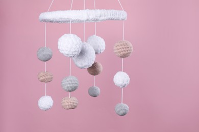 Cute baby crib mobile on pink background