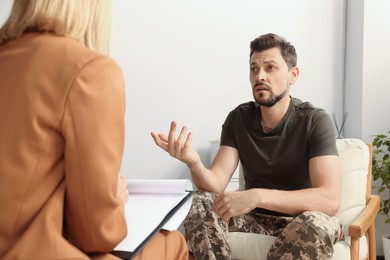 Psychologist working with military officer in office