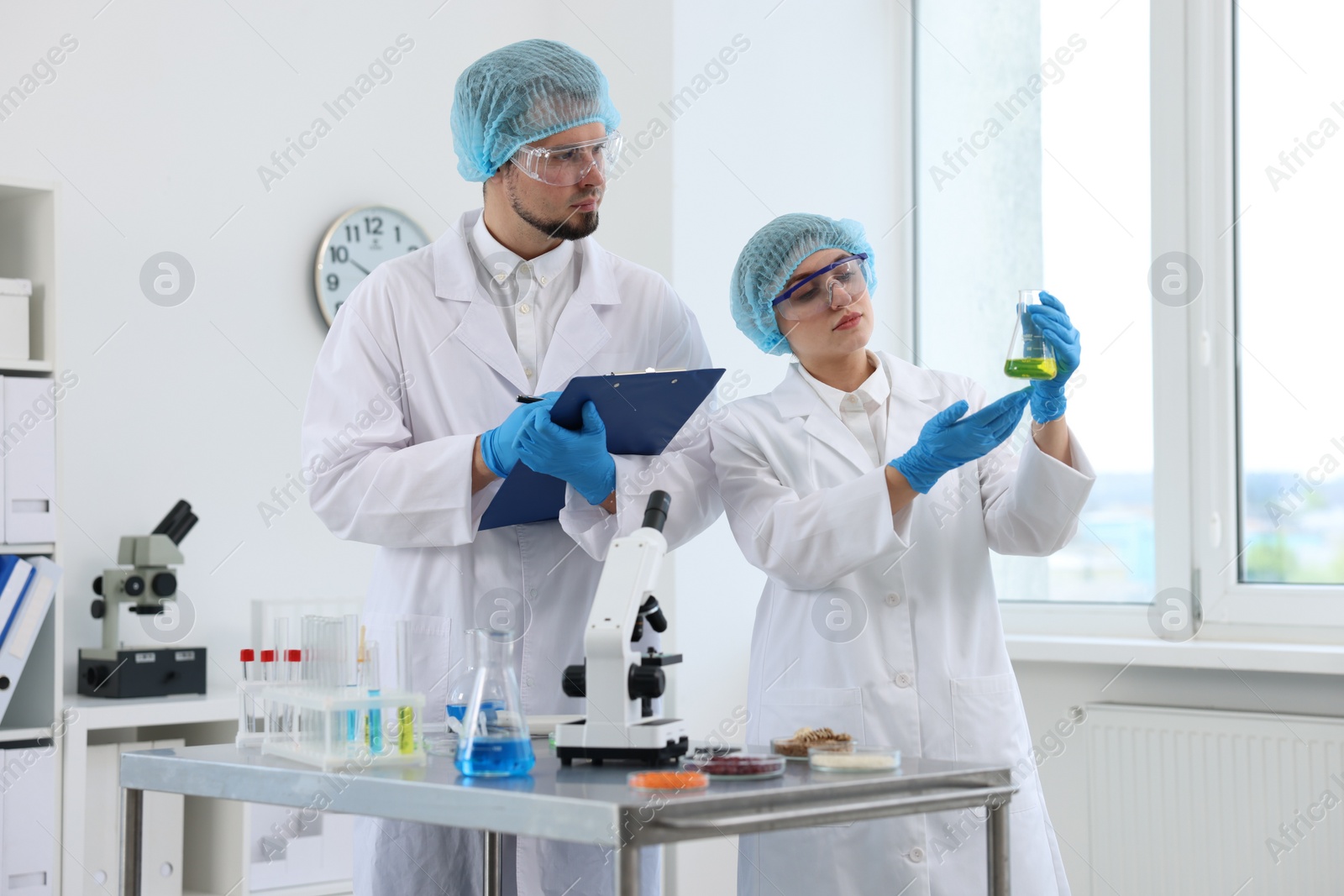 Photo of Quality control. Food inspectors checking safety of products in laboratory