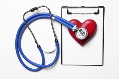 Photo of Stethoscope, red decorative heart and clipboard on white background, top view