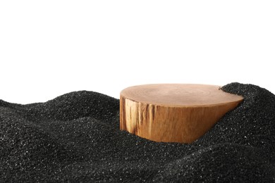 Photo of Presentation of product. Wooden podium on black sand against white background