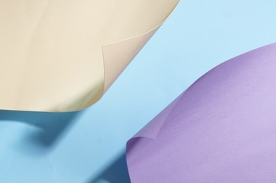 Different colorful paper sheets on light blue background