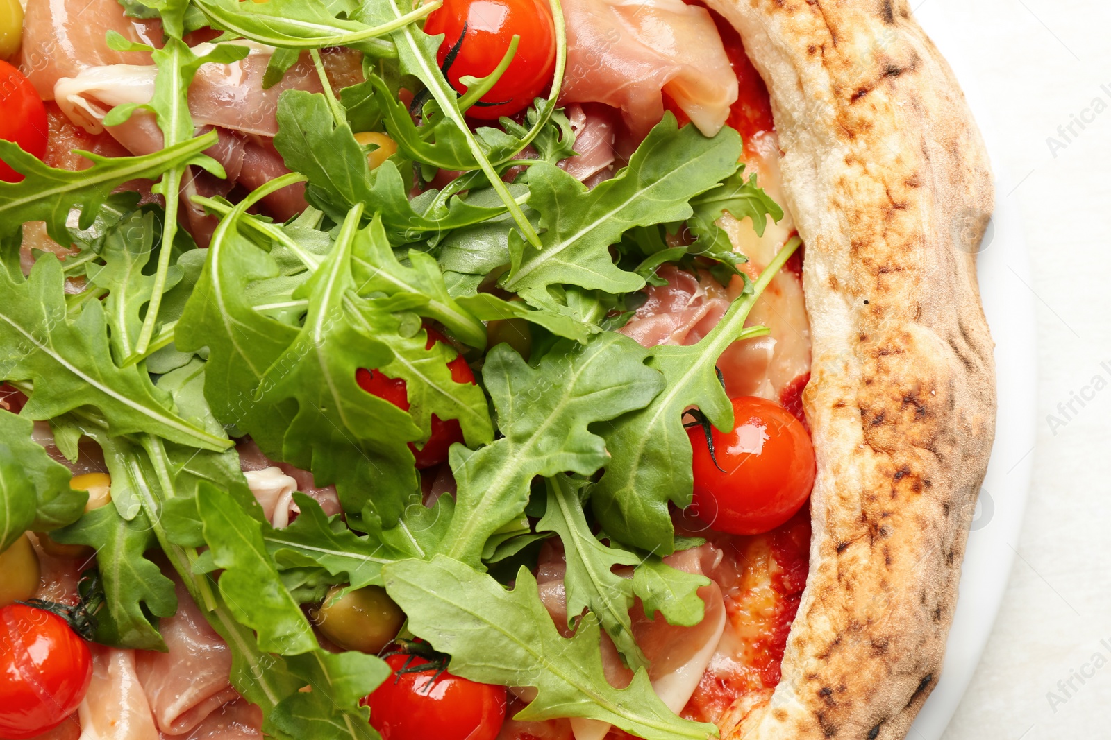 Photo of Tasty pizza with meat and arugula on white table, top view