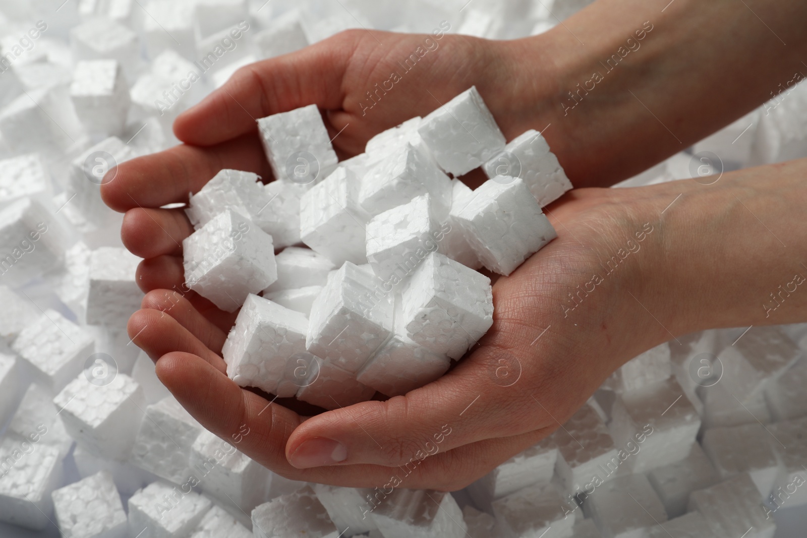 Photo of Woman with styrofoam cubes, closeup of hands