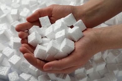 Woman with styrofoam cubes, closeup of hands
