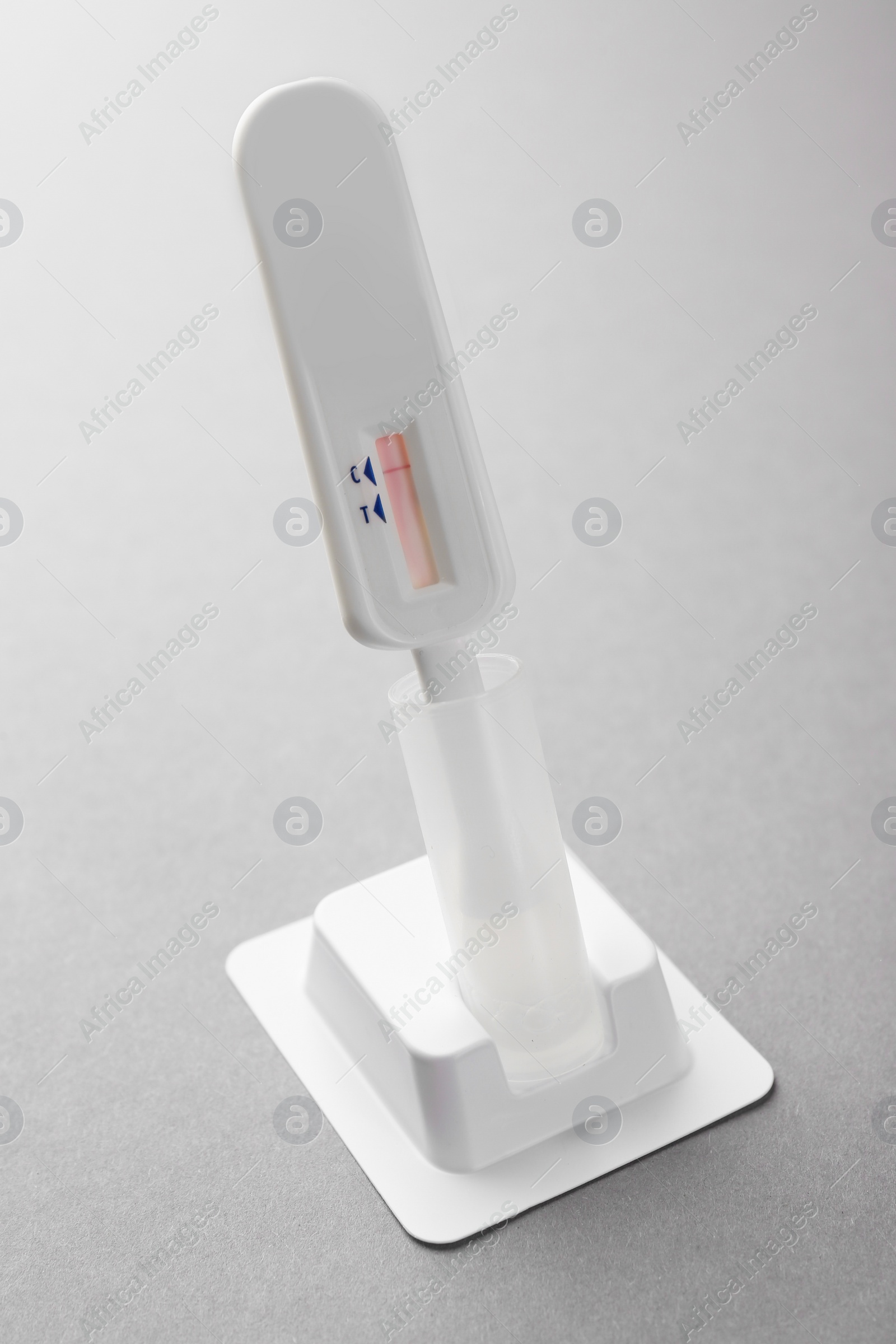Photo of One disposable express test on light grey background