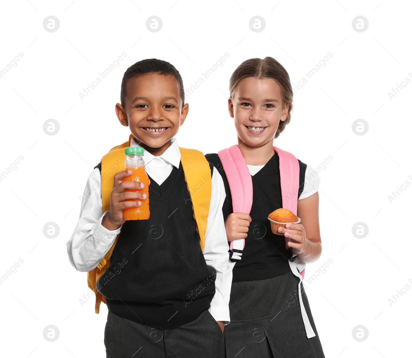 Photo of Schoolchildren with healthy food and backpacks on white background