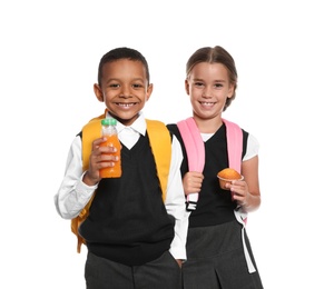 Photo of Schoolchildren with healthy food and backpacks on white background