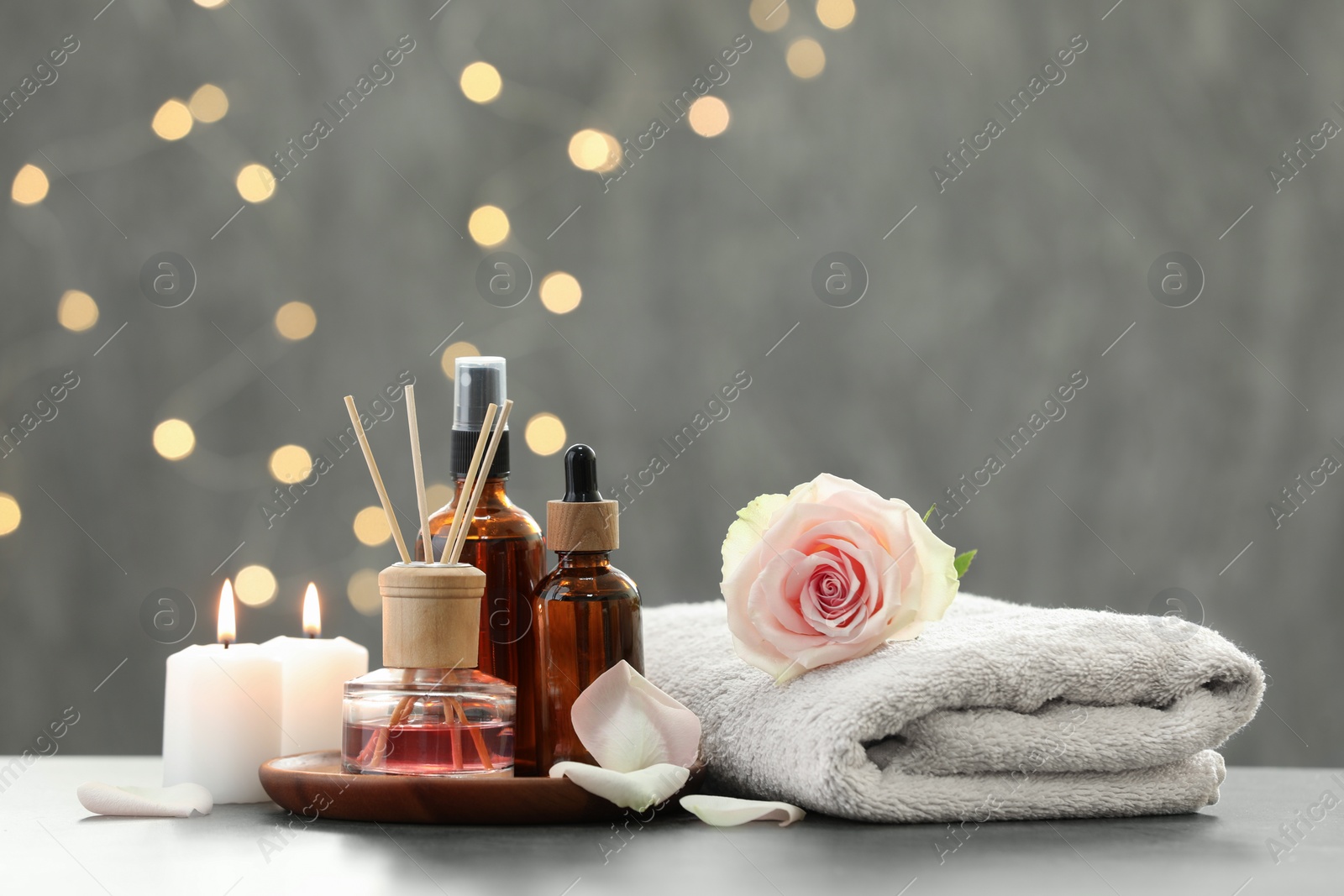 Photo of Composition with different spa products and rose flower on light table