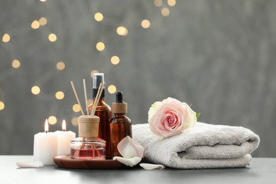 Photo of Composition with different spa products and rose flower on light table