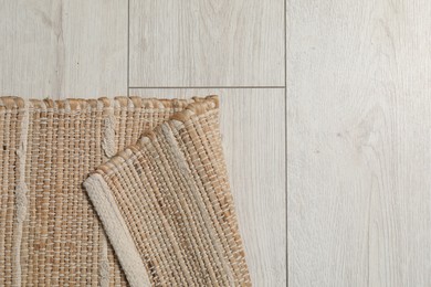 Soft carpet with pattern on white laminated floor indoors, top view. Space for text