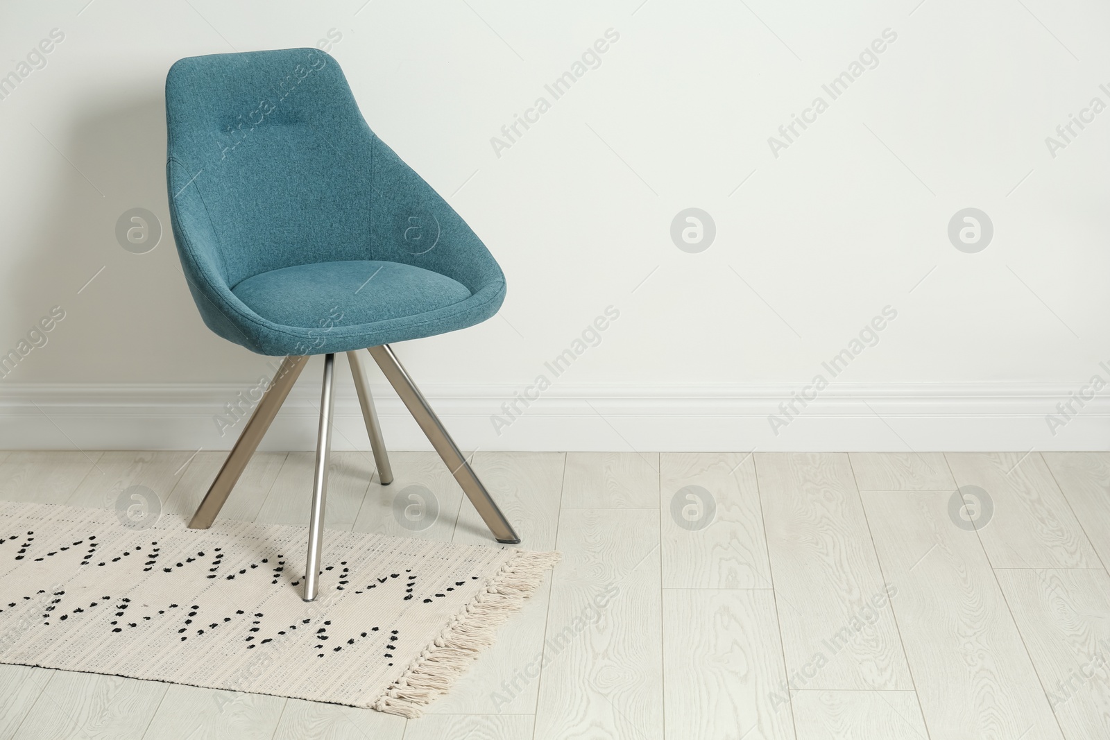Photo of Stylish dark green chair near white wall indoors. Space for text