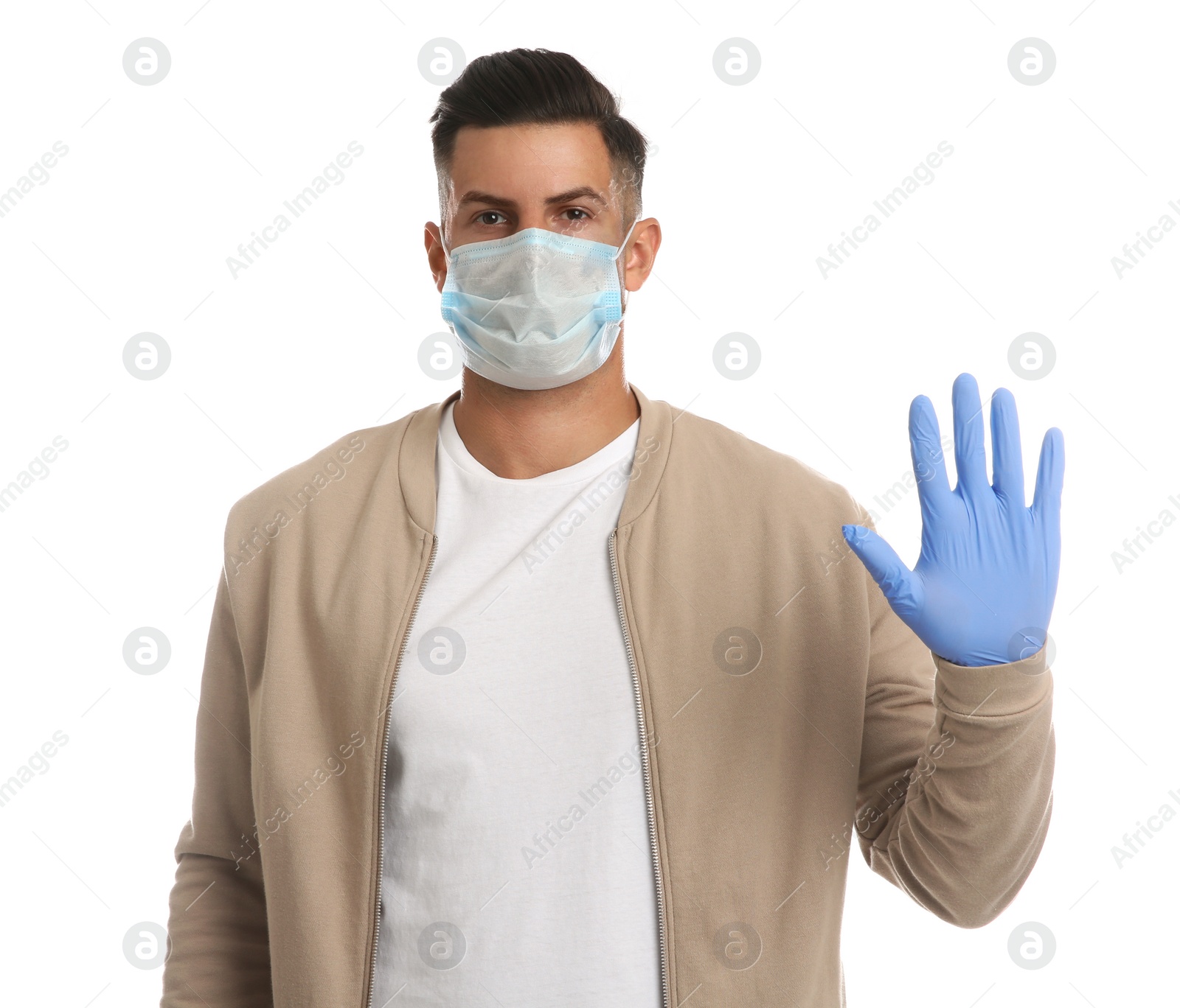 Photo of Man in protective face mask and medical gloves showing stop gesture on white background