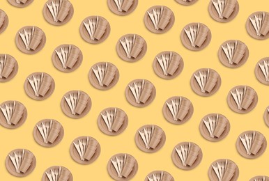 Image of Many disposable paper tableware on beige background, flat lay. Seamless pattern design