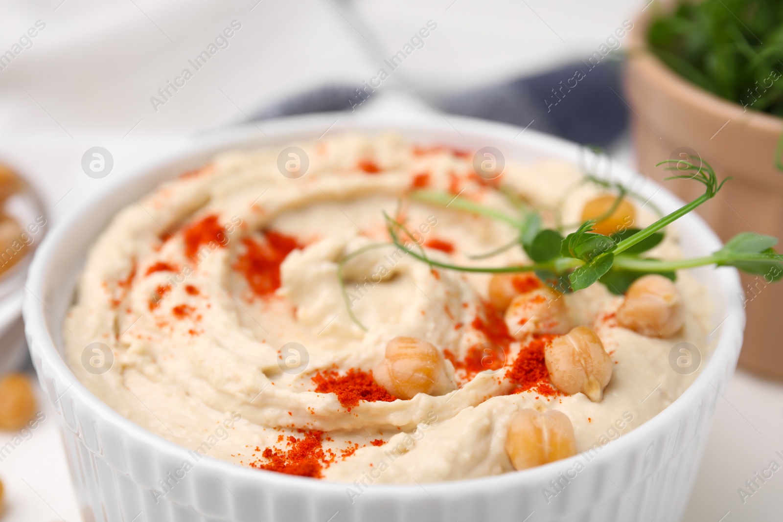Photo of Delicious hummus with chickpeas and paprika, closeup