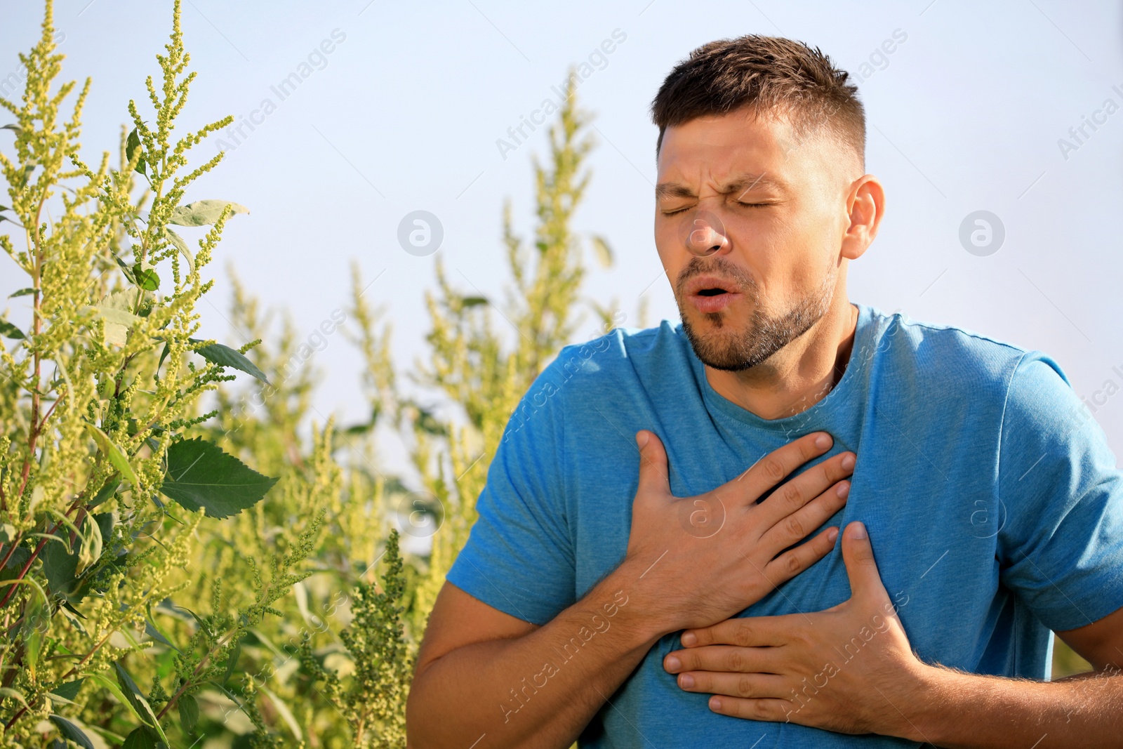 Photo of Man suffering from ragweed allergy outdoors on sunny day