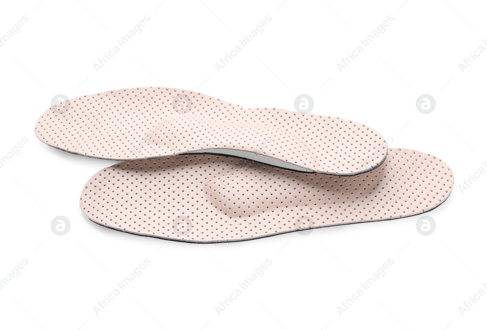 Photo of Beige comfortable orthopedic insoles isolated on white