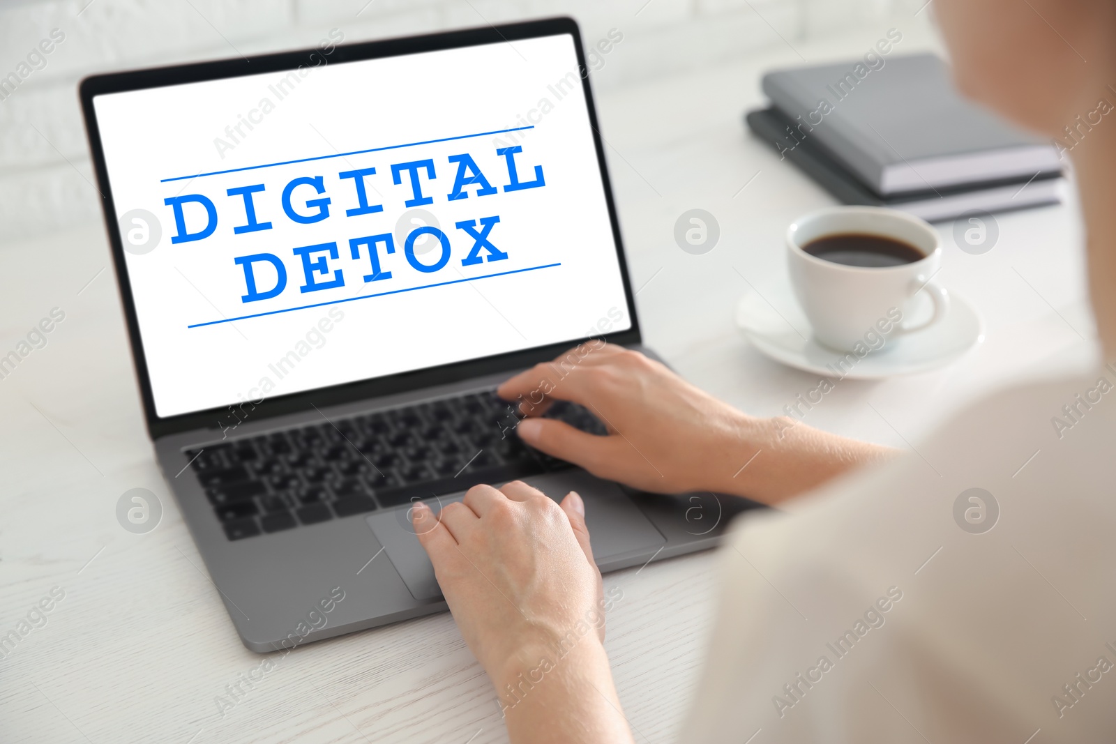 Image of Woman using laptop with text Digital Detox at table, closeup