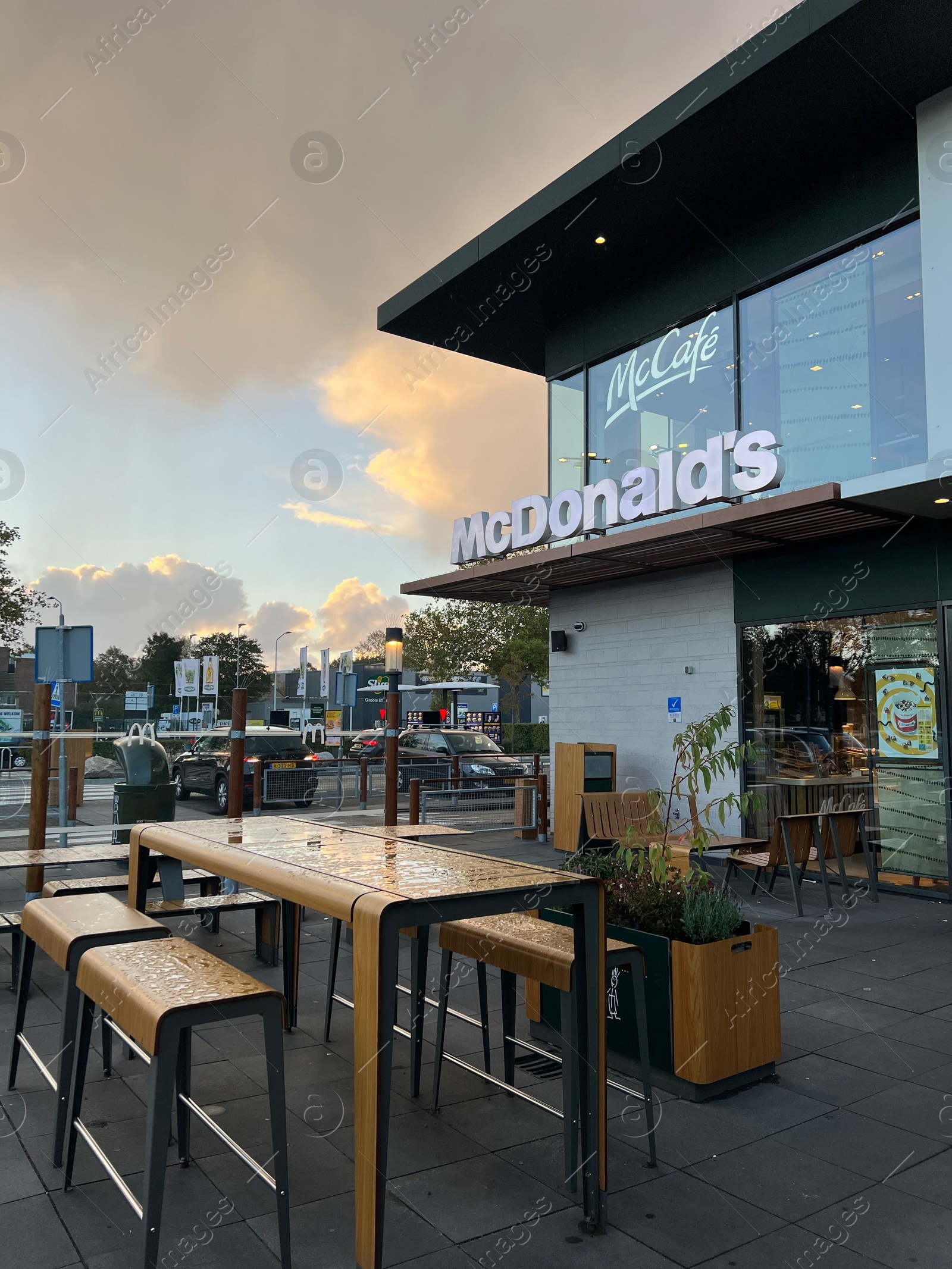 Photo of Leiden, Netherlands - October 15, 2023: Chairs and tables near McDonald's restaurant in city